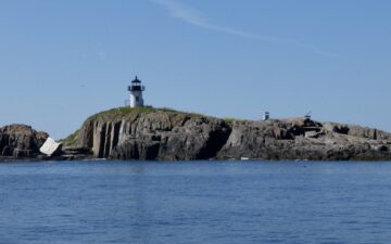 Lighthouse on a rocky outcrop.